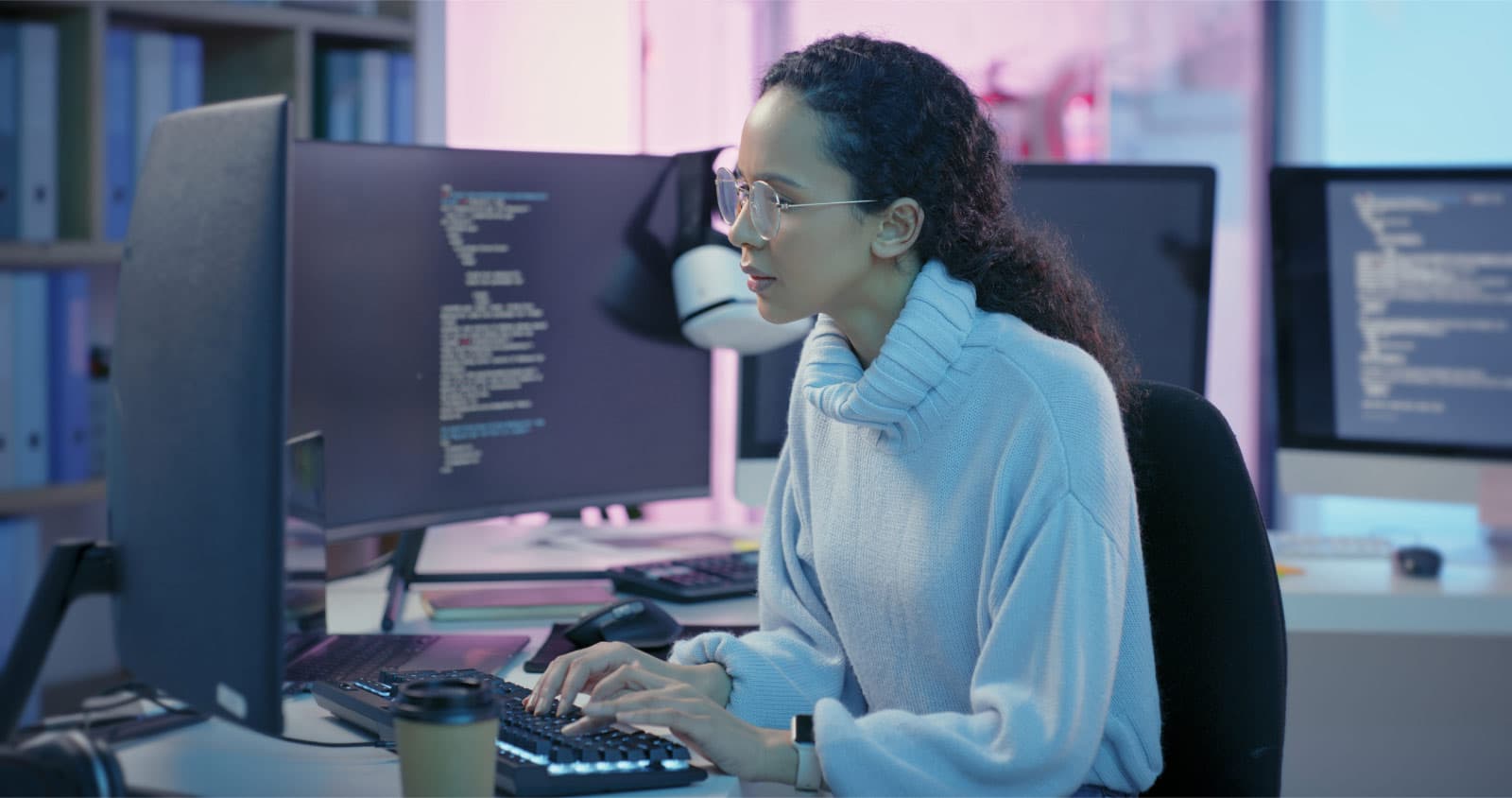 Woman looking intensely at computer screens in front of her